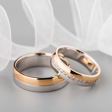 Two wedding bands sit on a gold platter waiting for the wedding ceremony. 