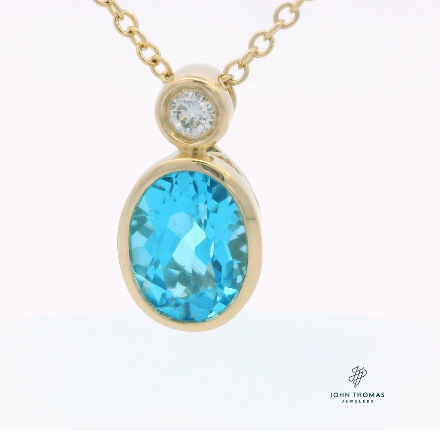 BLUE TOPAZ AND DIAMOND PENDANT IN 14K YELLOW GOLD